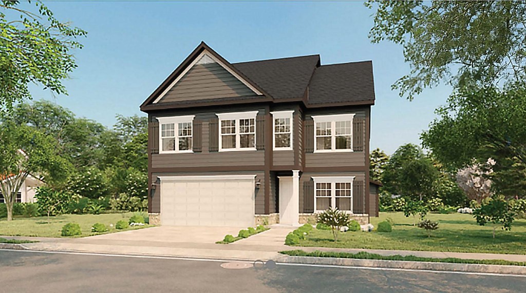 A two-story house with a garage is surrounded by greenery.