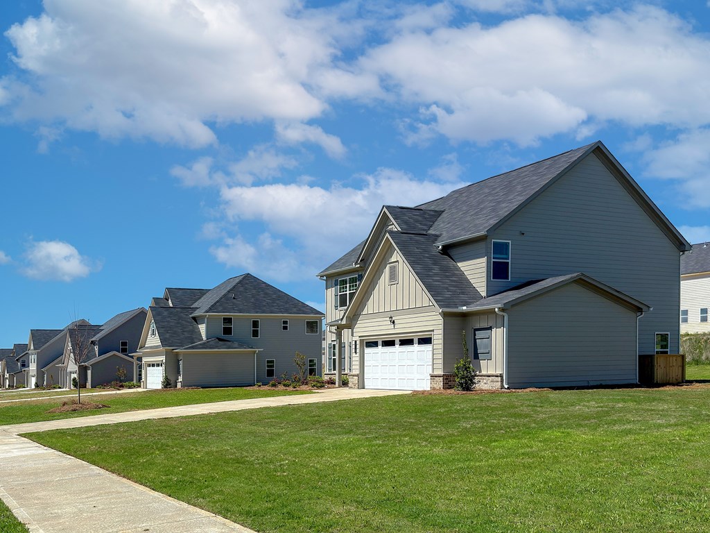 A row of houses with a clear blue sky above them.