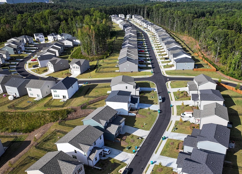 A row of houses with a road running through the middle.