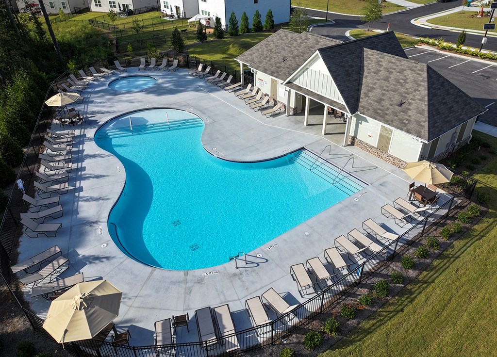 A large outdoor swimming pool surrounded by lounge chairs.