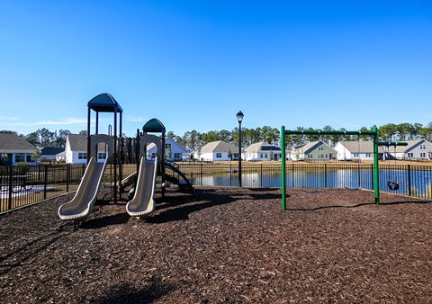 A playground with a slide and a tower.