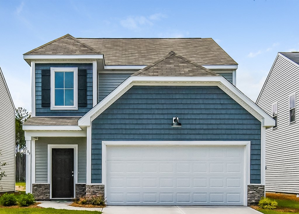 A blue house with a white garage door.
