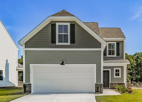 A two-story house with a garage door in the front.