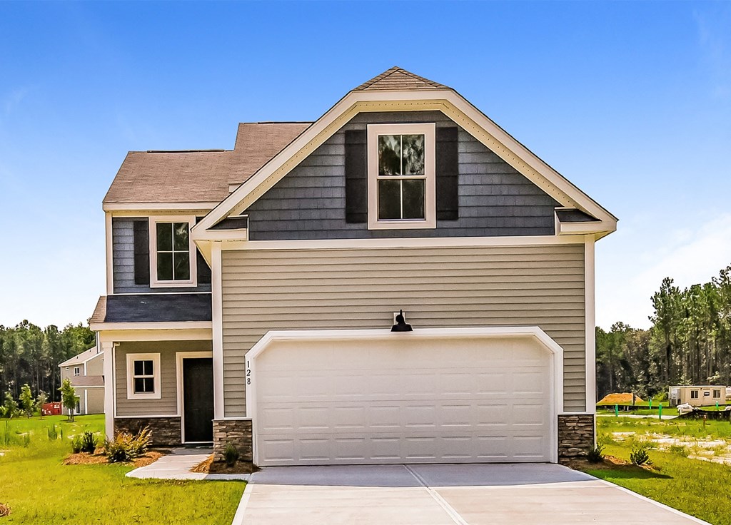 A two-story house with a garage door.