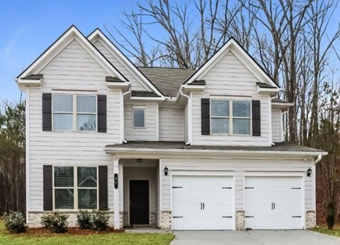 A two-story house with a white garage door.