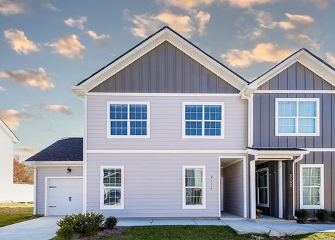 A modern two-story house with a garage.