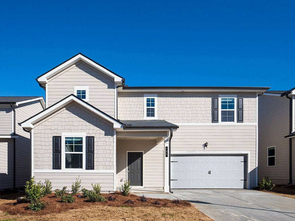 A two-story house with a garage is shown.