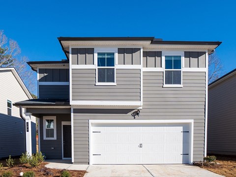 A modern two-story house with a garage.
