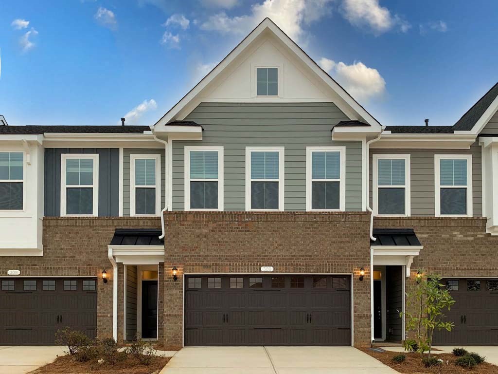 a new house with a garage door in front of it