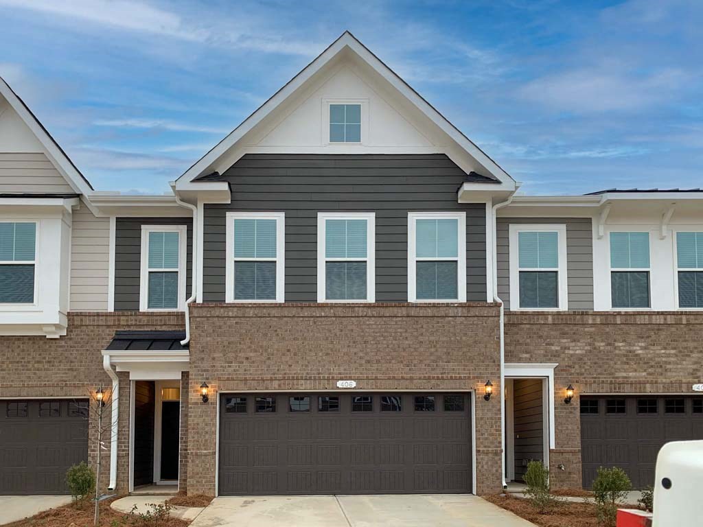a house with a garage door in front of it