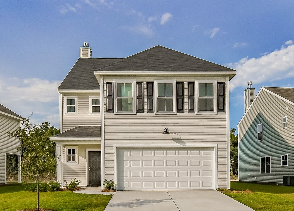 A two-story house with a garage is shown in the image.