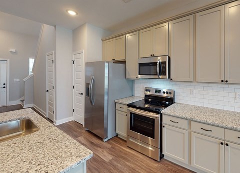 A kitchen with a stove top oven and a microwave above it.
