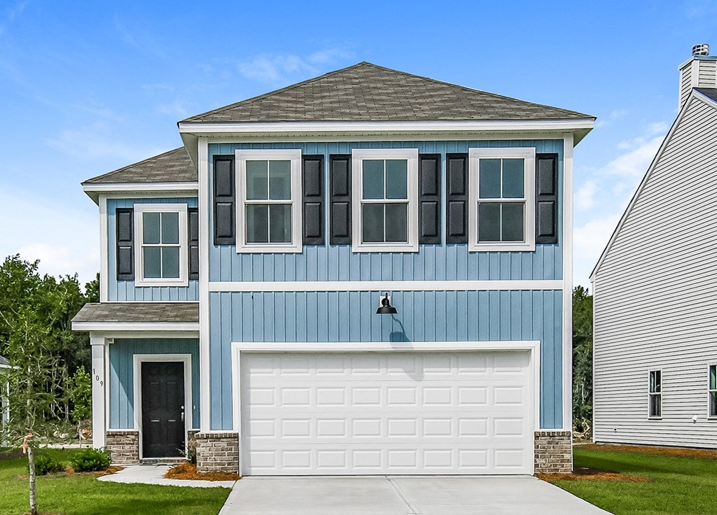 A blue house with a white garage door.