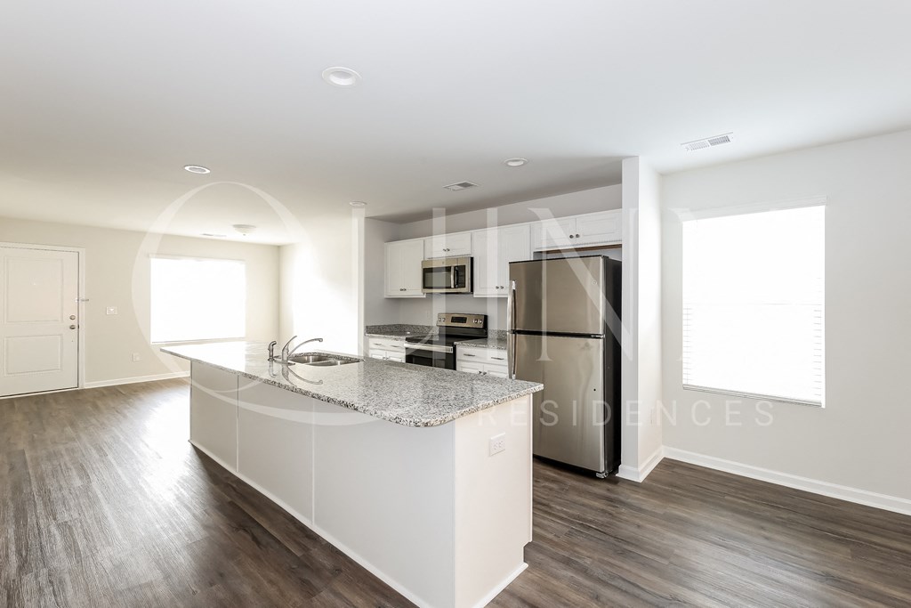 a kitchen with an island and stainless steel appliances