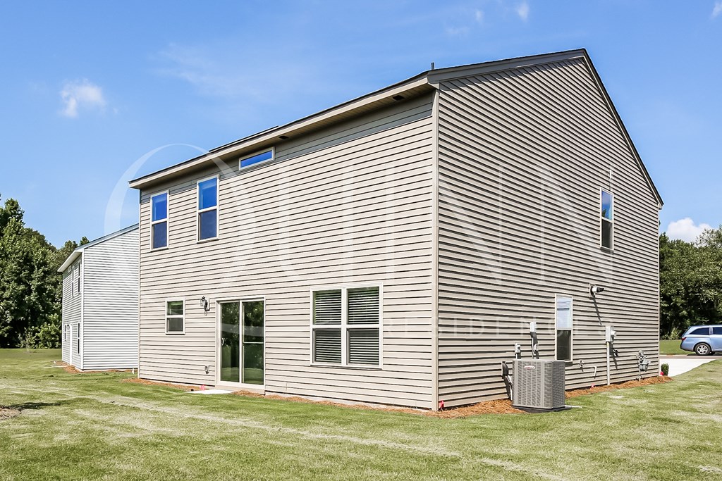the back of the house with siding on it
