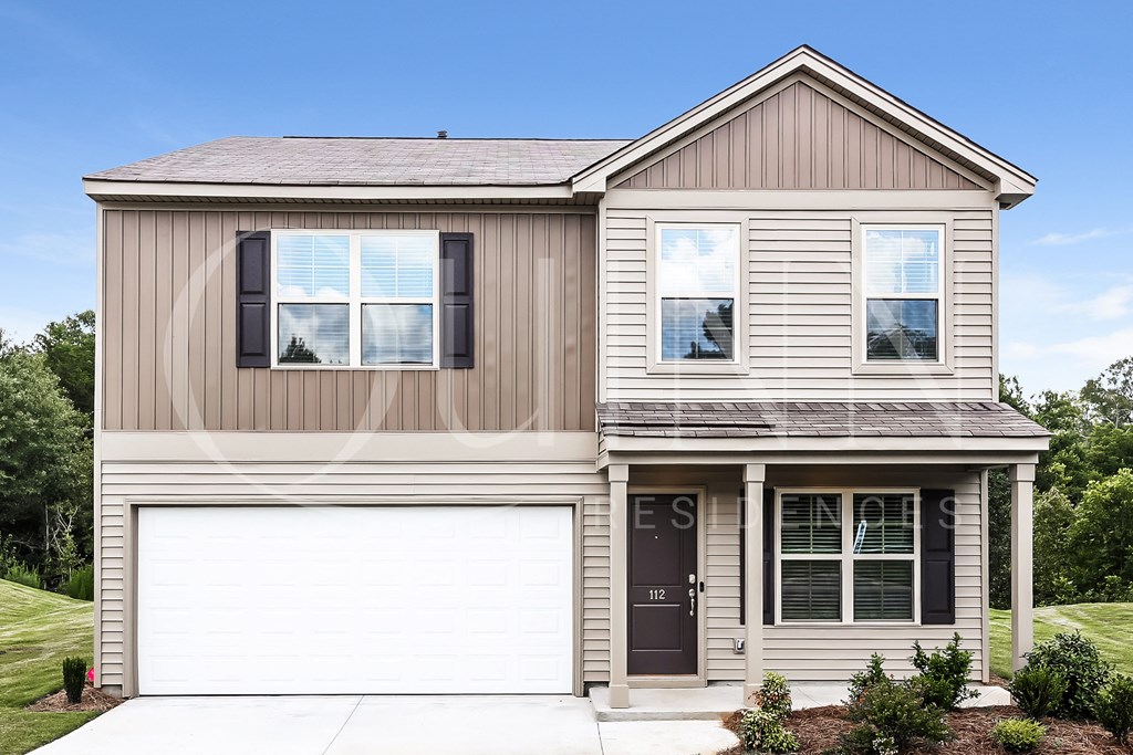 a home with a white garage door and brown siding