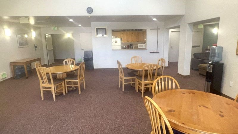 an empty dining room with tables and chairs