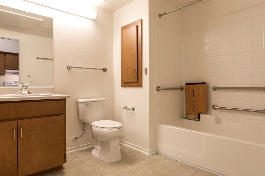 a bathroom with a toilet and a sink and a bath tub