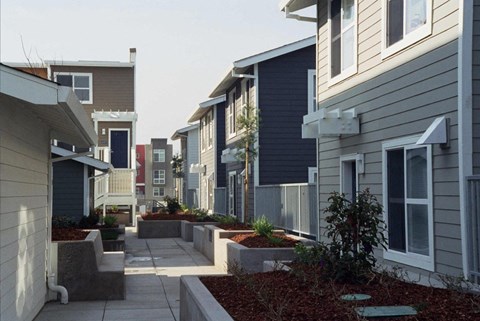a row of houses with a sidewalk in front of them