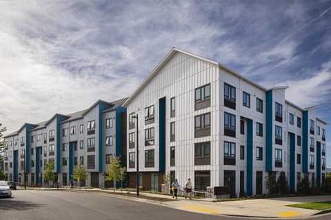 A modern apartment building with a white and blue exterior.