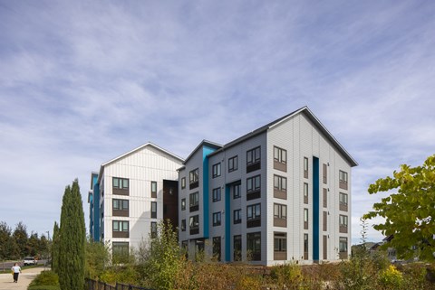 A modern building with a mix of white and blue exterior.
