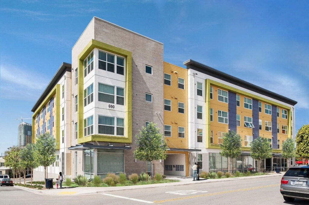 a new apartment building on the corner of a city street
