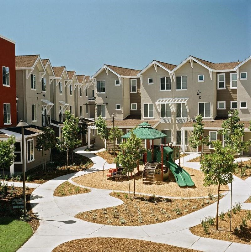 an outdoor play area in the middle of an apartment complex