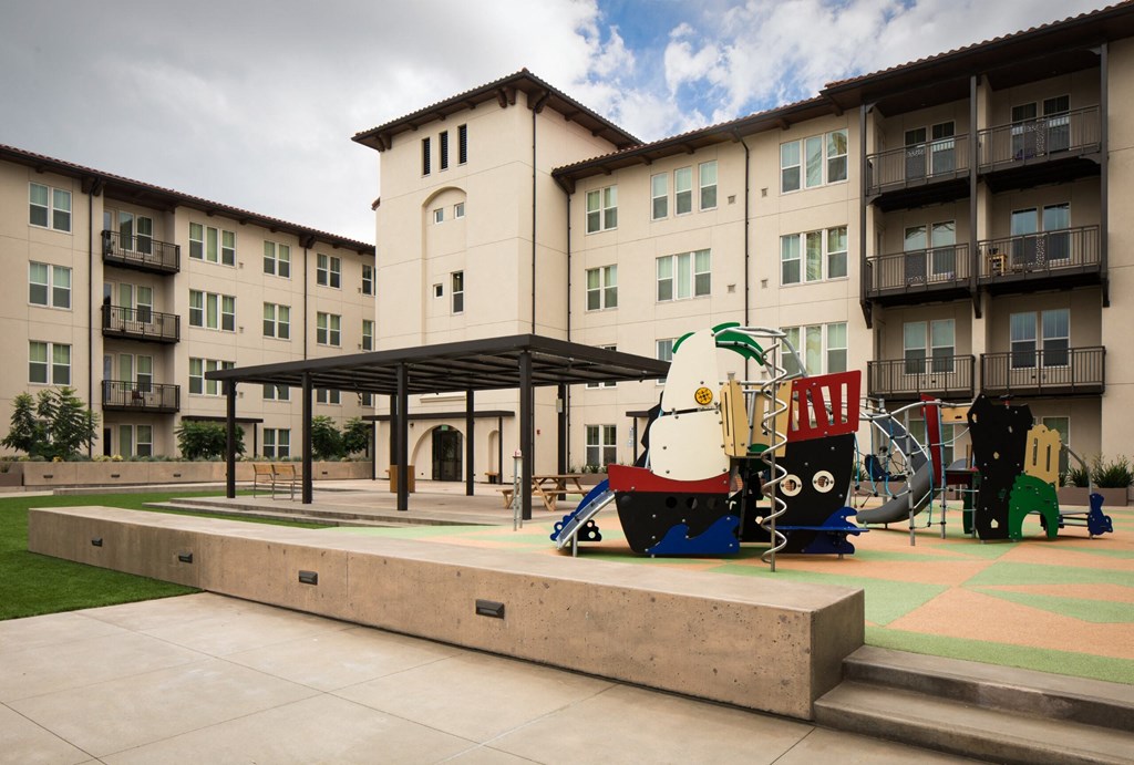 a playground in the middle of an apartment building