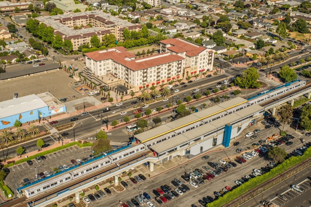 an aerial view of a train on the tracks in a city