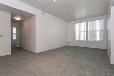 the living room of an empty house with a large window