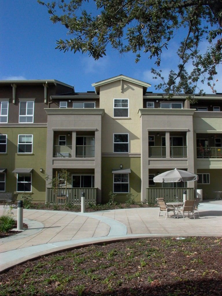an outdoor patio in front of an apartment building