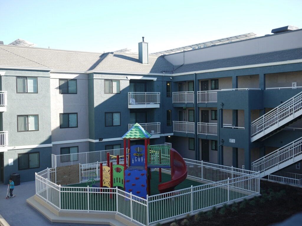 a large building with a playground in the middle of it