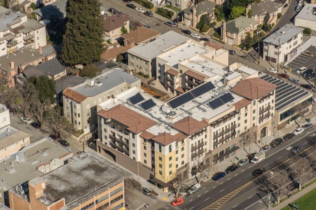 an aerial view of a city with buildings and cars