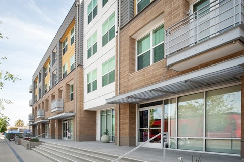 a view of the side of a building with windows and a sidewalk