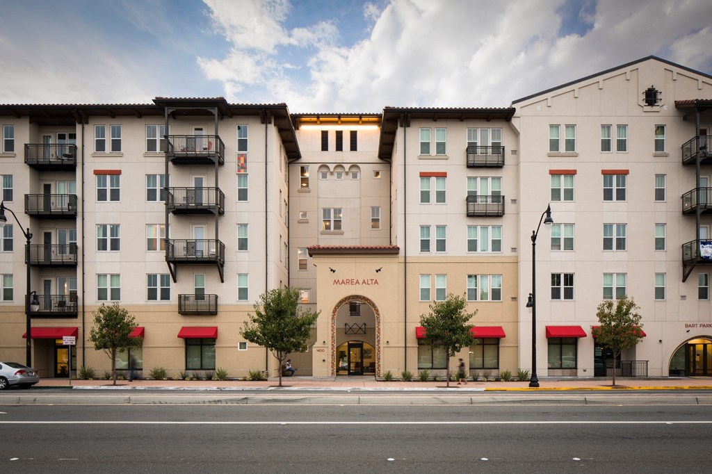 a street view of an apartment building on a city street