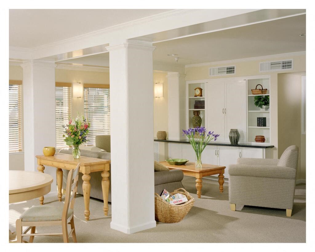 a living room and dining room with a table and chairs