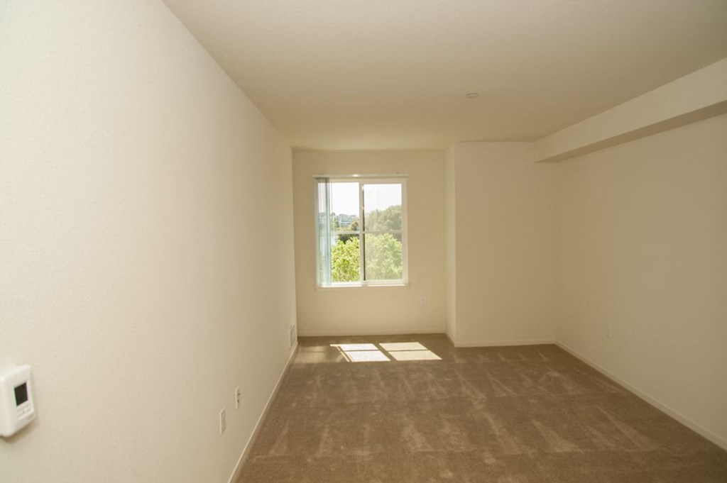 the living room of an empty house with a window
