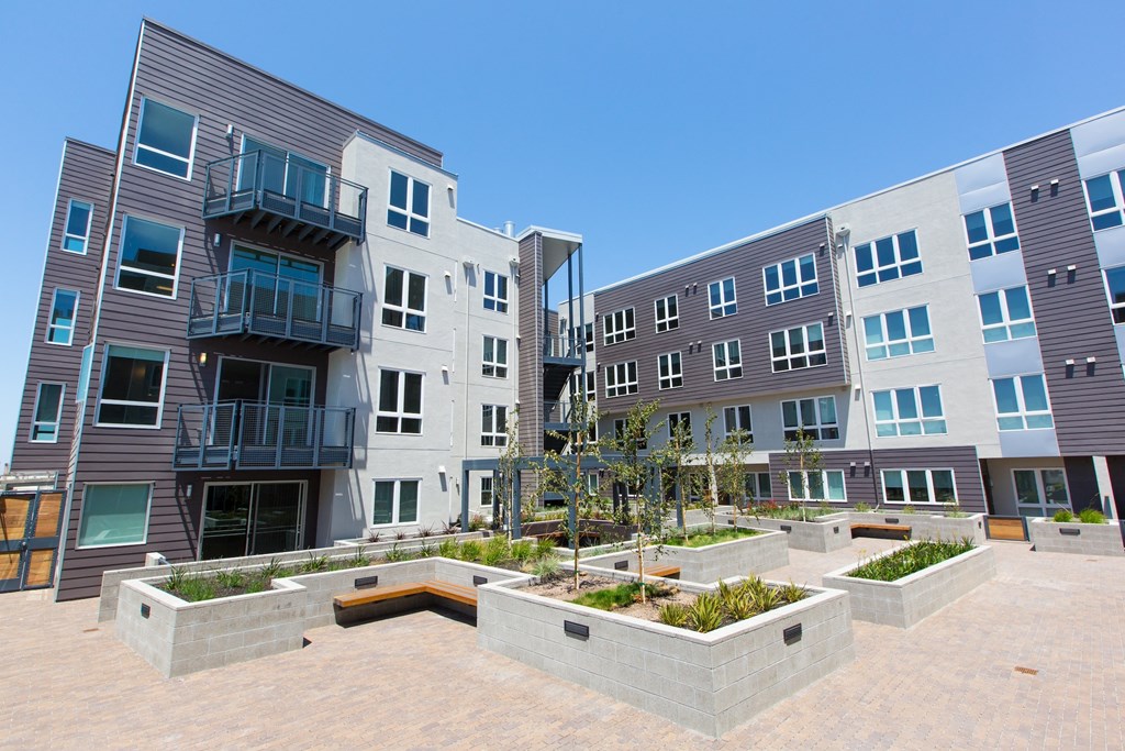 a group of modern apartment buildings with a courtyard at Viewpoint, Berkeley, CA