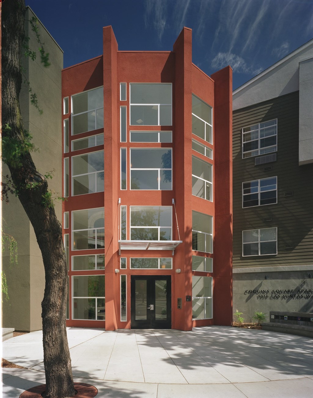 a red building with a tree in front of it