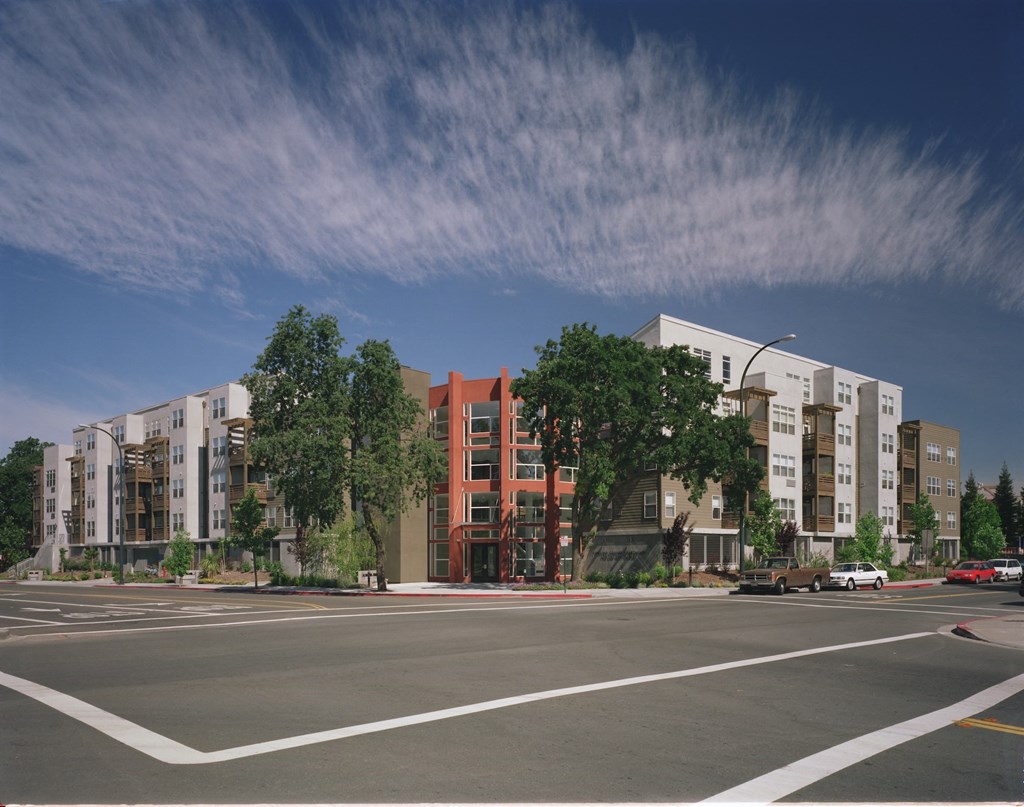 a rendering of an apartment building on a city street