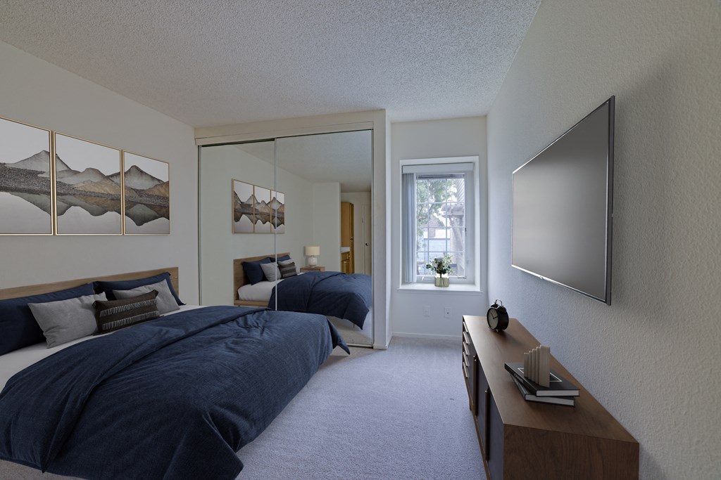 a bedroom with two beds and a dresser and a window