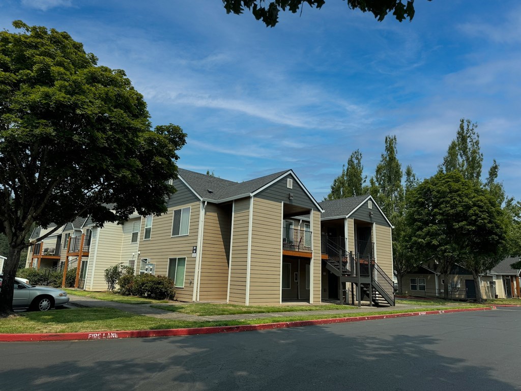 a row of houses with a street in front of them