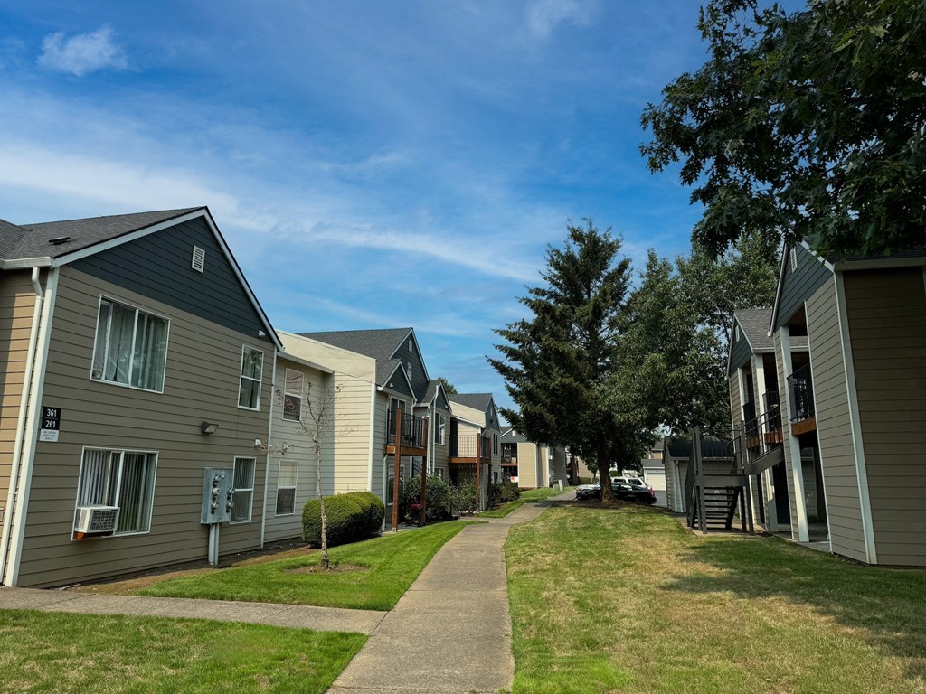 a row of houses on the side of a sidewalk