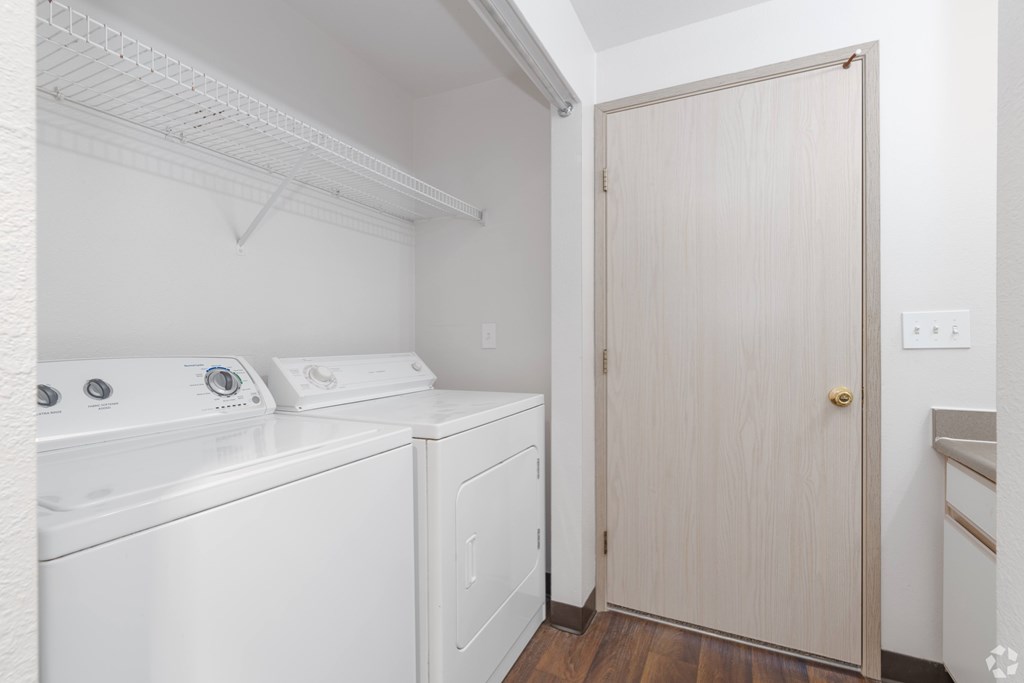 A small laundry room with a washer and dryer.