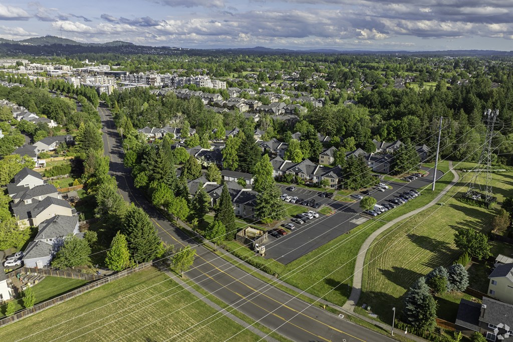 A suburban neighborhood with a large intersection and a road running through it.