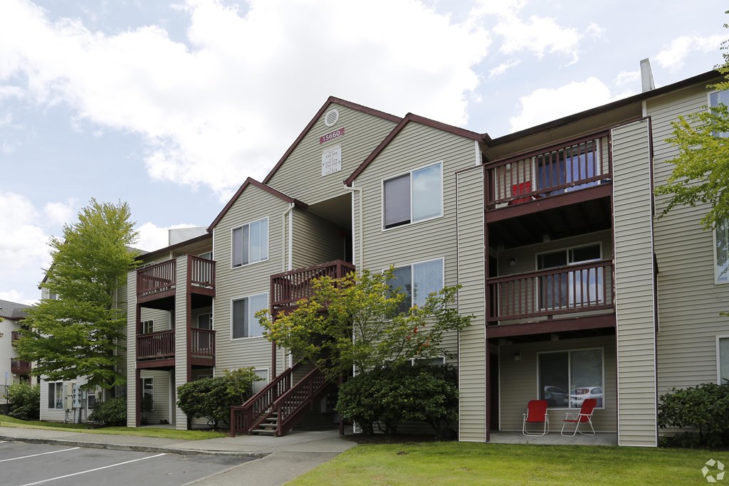 Apartment building with a red chair on the balcony.