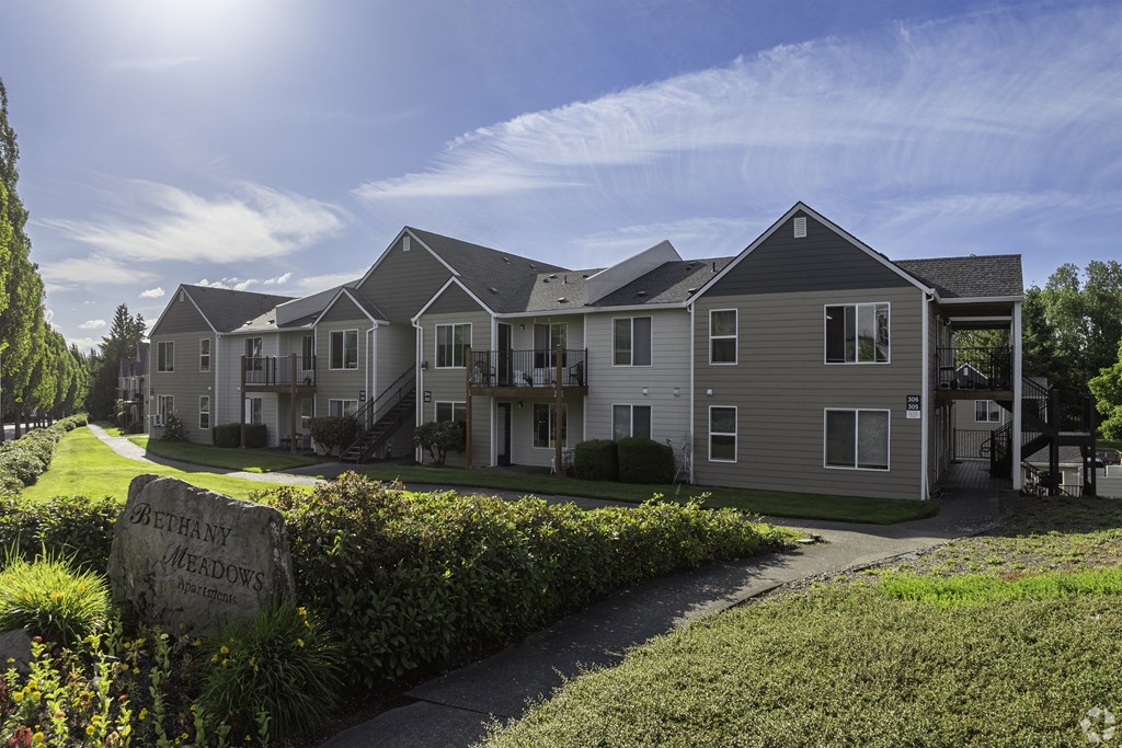 A sunny day at Bethany Woods residential complex with houses and a clear sky.