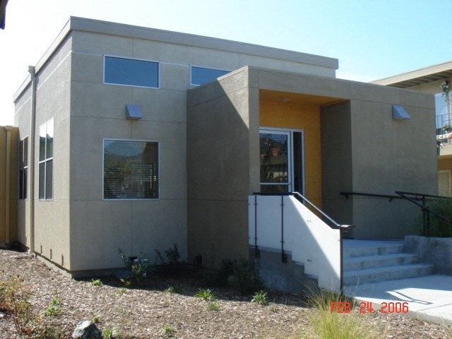 a small house with stairs and a front door