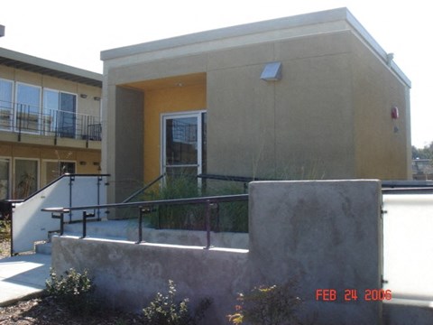 the front of a building with stairs and a glass door