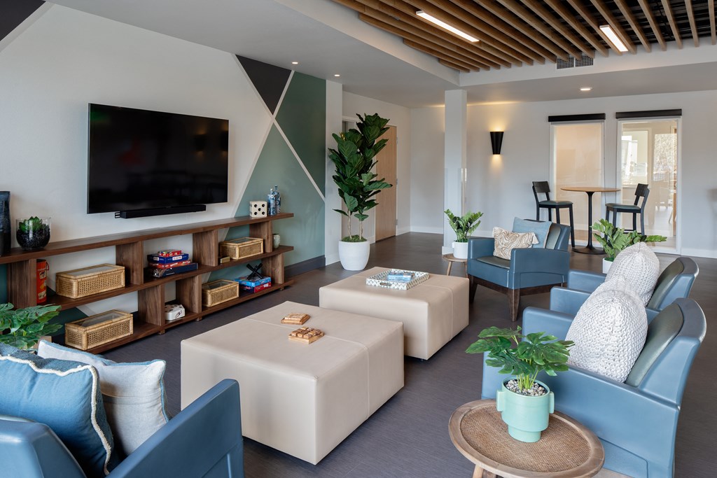 a living room with blue and white furniture and a television